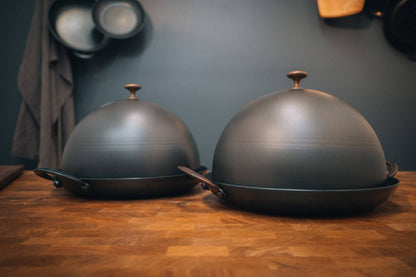 Bread Cloche domes for 11 inch roaster, spun 14 gauge carbon steel with copper knobs, creating rustic loaf heat retention inside.
